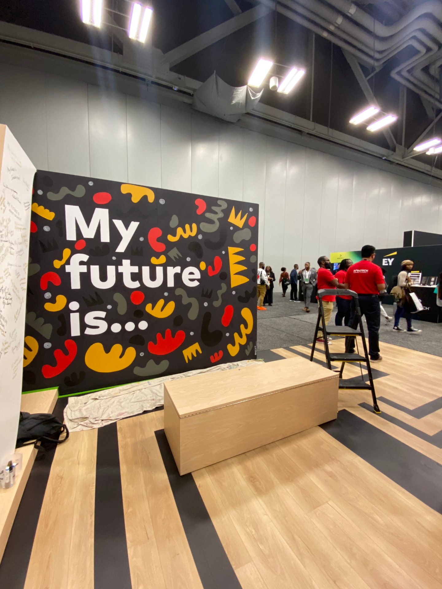 Large painted 'My future is...' mural panel at a conference activation